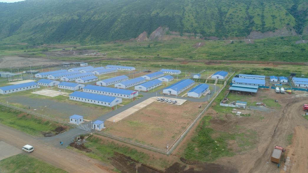 Aerial view of an established project camp in a green landscape