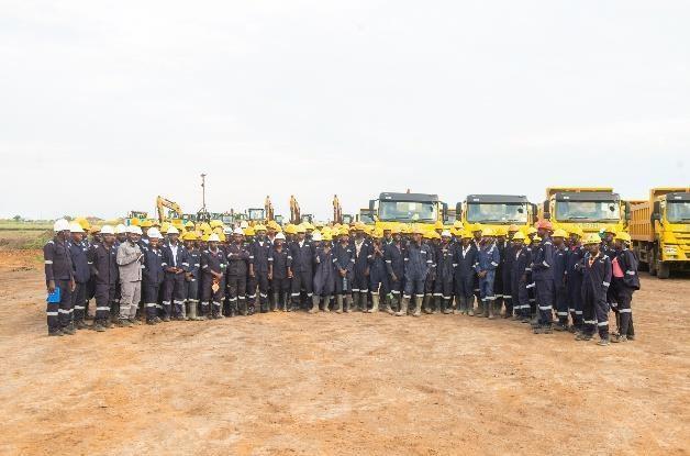 A Spary Race team assembled in protective equipment with construction machinery