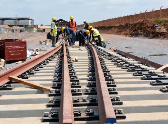 Railway track installation with a crew working on the line